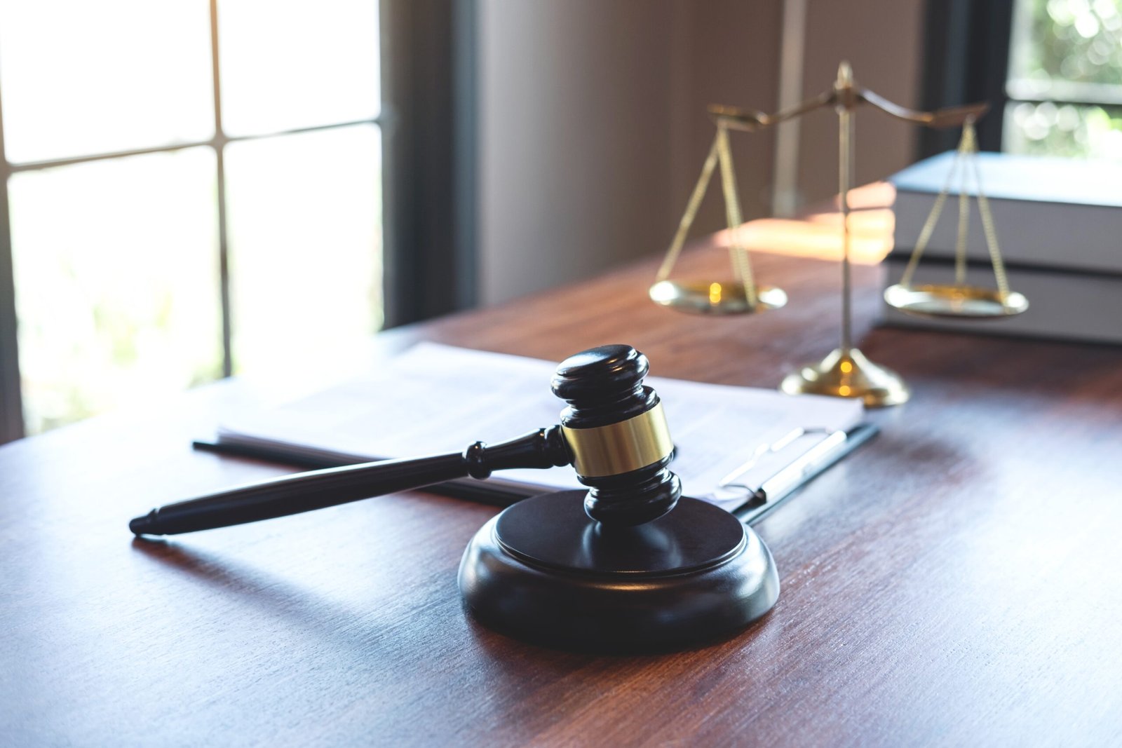 Judge gavel with Justice at law firm in background with legal ca